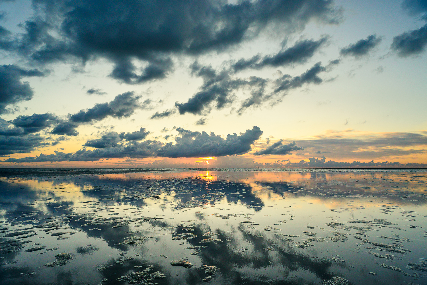 Fotografie am Strand der Nordseeinsel mit Wolkenspiegelungen im Sand
